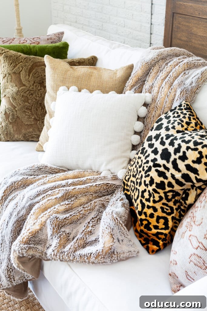 Creating a Cozy Fall Living Room Sanctuary 4 A collection of textured and patterned pillows on a sofa in a fall decorated living room.