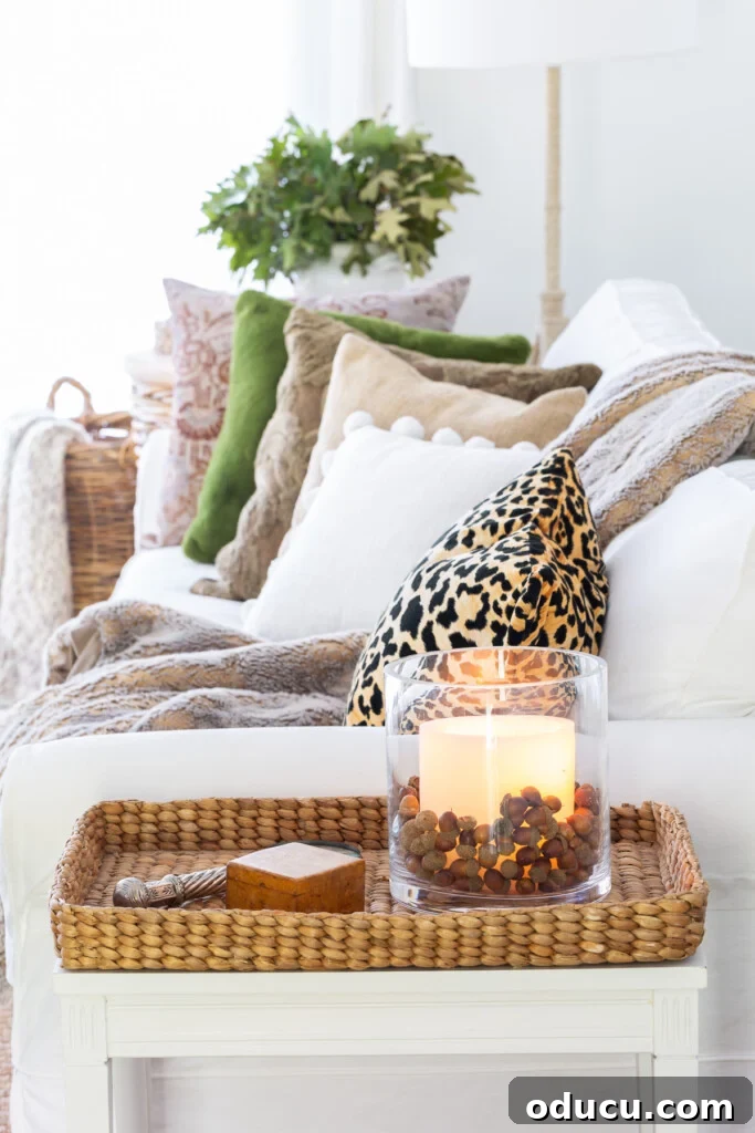 Creating a Cozy Fall Living Room Sanctuary 5 Side view of a white sofa with fall colored throw pillows on it.