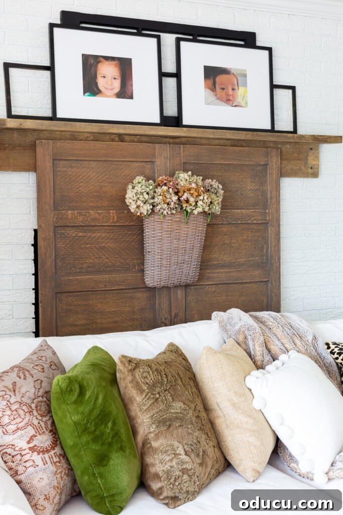 Creating a Cozy Fall Living Room Sanctuary 6 View of reclaimed wood fireplace mantel with black photos frames on top.