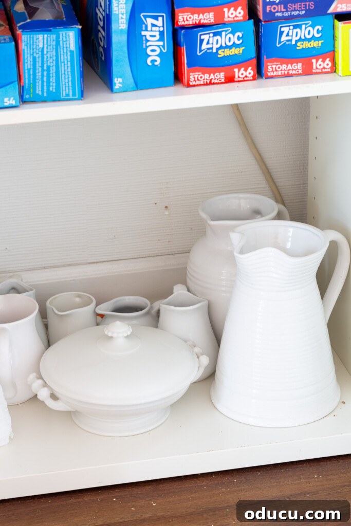 Modern Kitchen Renovation Butler Pantry and Hidden Murphy Door 13 White pitchers being stored in a Butler's pantry cabinet.