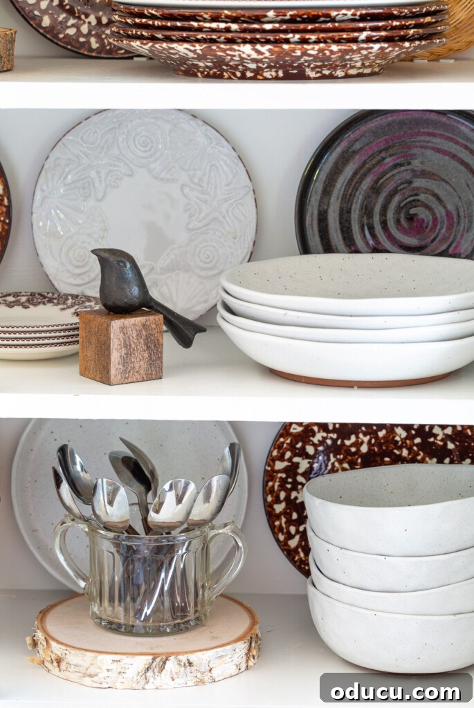 Mutfağımda Sonbahar Esintileri: Büyük Bir Yenilik Geldi! 15 A collection of plates displayed on open shelves in a kitchen, mixed in with a few decorative fall accessories.