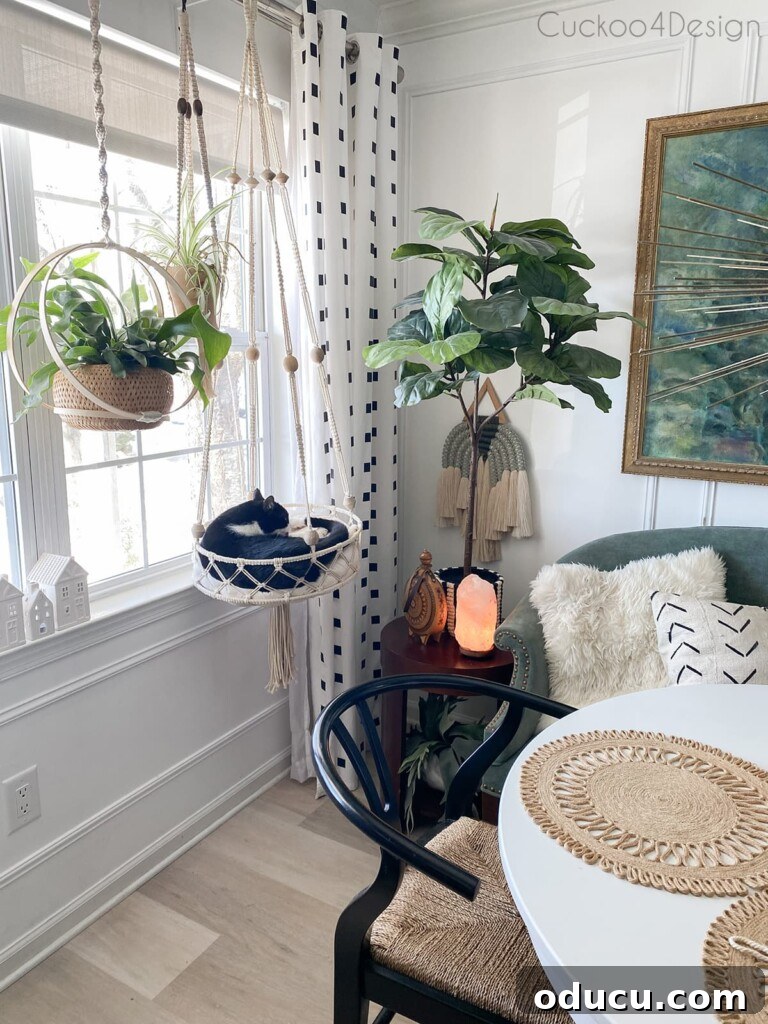 Discover Your Signature Decor Style 11 Cuckoo for Design's dining area with macrame DIY cat bed hanging in front of a window.