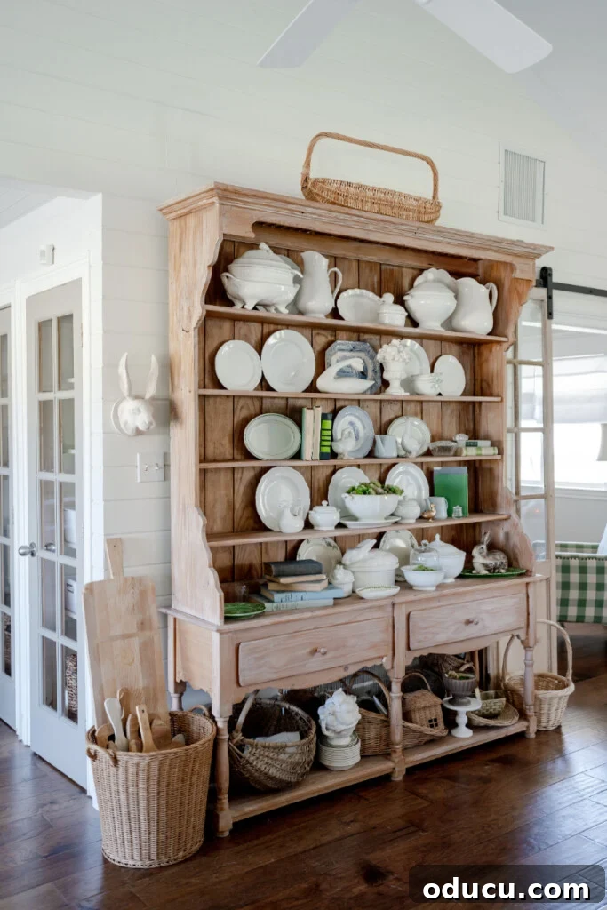 My Little White Barn's pine hutch filled with white serveware and green accents.