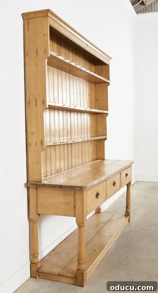 an empty Country English pine Welsh cupboard