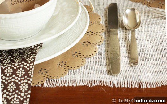 Simple & Stunning Thanksgiving Table Settings 6 Close up of white plates on a Thanksgiving table setting with layered placemats