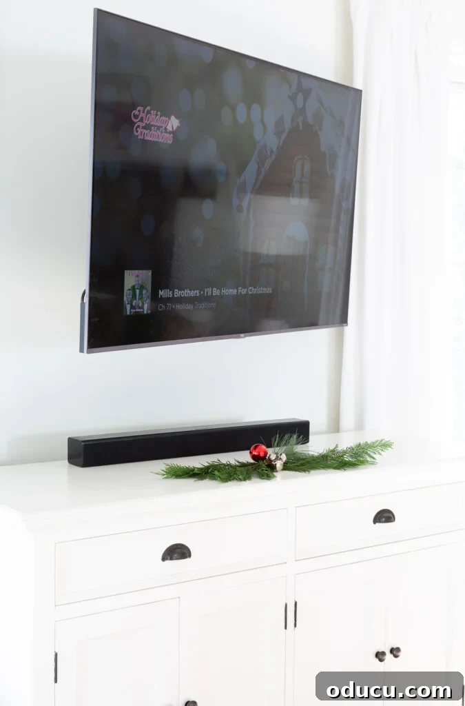 Showcase Your Holiday Cards: DIY Mantel & Table Display 2 Empty sideboard under wall mounted TV, awaiting festive decoration.