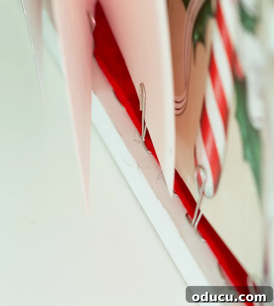 Showcase Your Holiday Cards: DIY Mantel & Table Display 11 Close-up demonstrating the proper way to place Christmas cards into the DIY card holder.