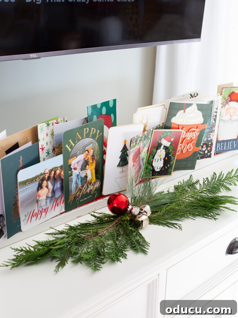 Showcase Your Holiday Cards: DIY Mantel & Table Display 14 A charming, long display of Christmas cards arranged on a console table, ready for festive gatherings.
