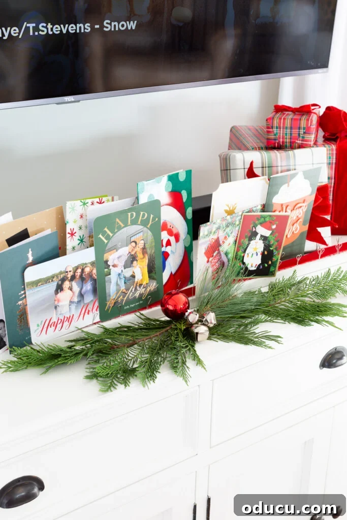 Showcase Your Holiday Cards: DIY Mantel & Table Display 3 Christmas cards beautifully displayed on a DIY wood holder on a table top.
