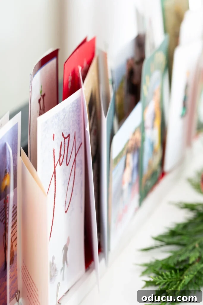 Showcase Your Holiday Cards: DIY Mantel & Table Display 5 A festive line up of Christmas cards beautifully arranged on a DIY display.