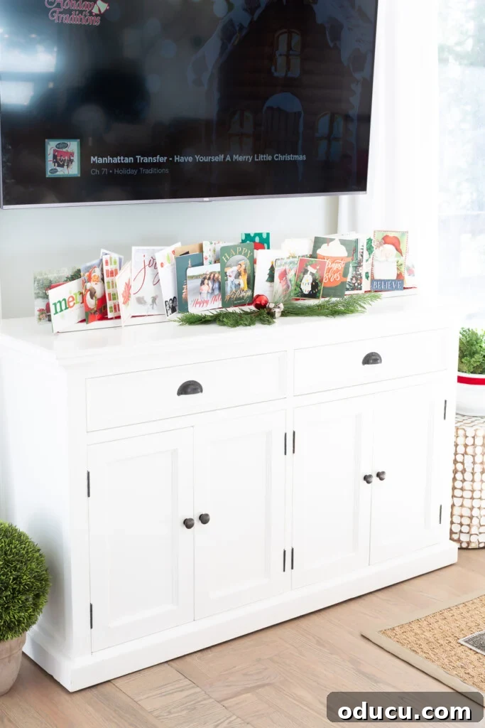 Showcase Your Holiday Cards: DIY Mantel & Table Display 6 DIY holiday greeting card stand elegantly placed on a sideboard under a wall mounted TV.