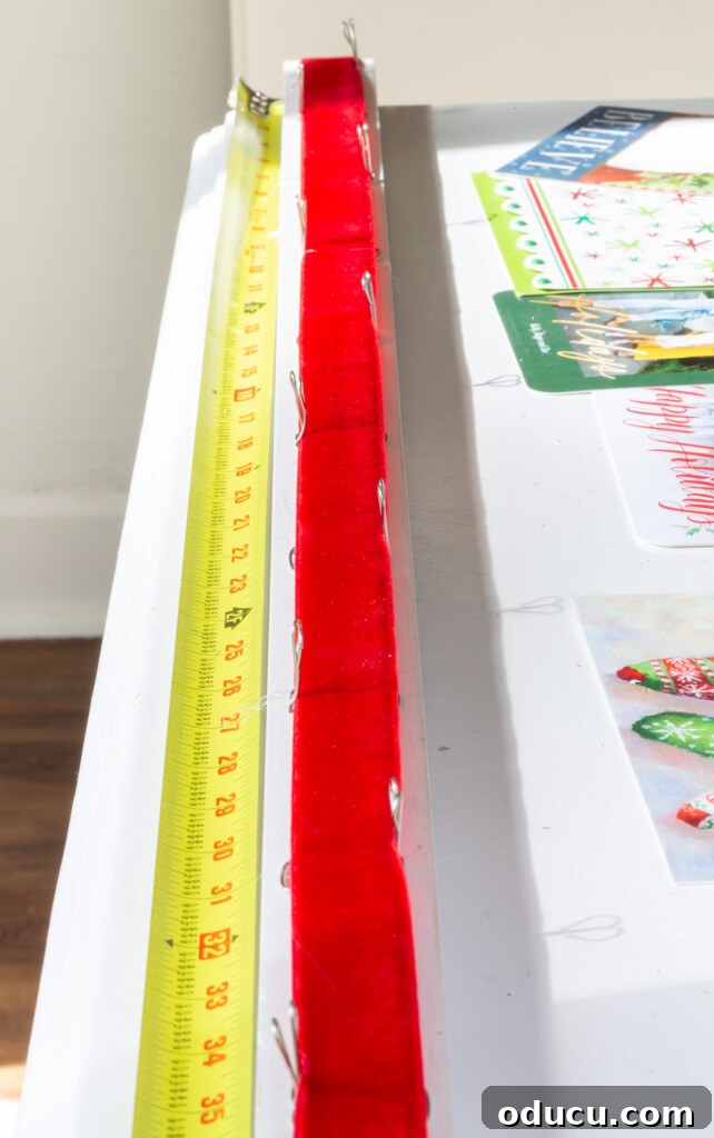 Showcase Your Holiday Cards: DIY Mantel & Table Display 10 Instructions on how to securely attach ribbon to the wood base when crafting the card holder.