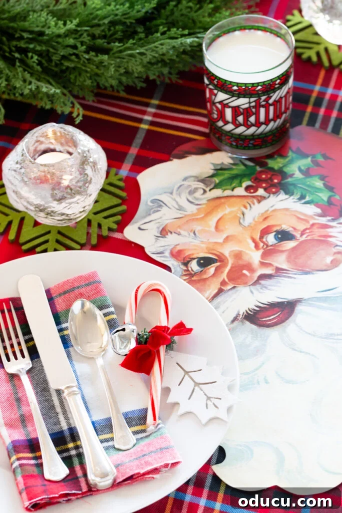 Joyful and Merry Christmas Dinner Table 2 Kid-friendly Christmas table setting idea featuring cheerful Santa face paper placemats, festive candy canes, and classic red plaid decorations.