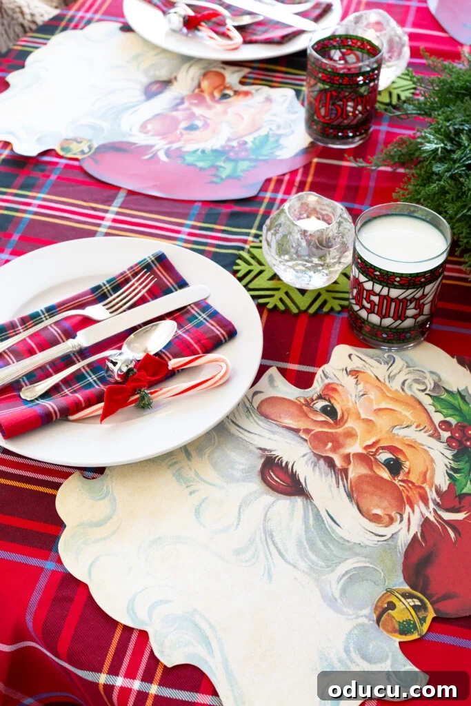 Joyful and Merry Christmas Dinner Table 5 Festive Christmas Santa dining table setting featuring Santa Claus face paper placemats by Hester & Cook on a round table with elegant dinnerware.