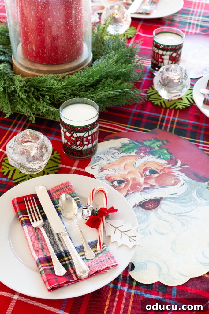 Joyful and Merry Christmas Dinner Table 7 Christmas round table set up with a cozy red plaid tablecloth and adorable Santa Claus face paper placemats, ready for a festive holiday meal.