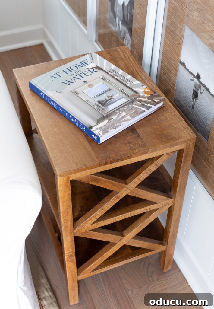 Effortless Winter Decor 8 Elegant X-design side table from HomeGoods, topped with the beautiful coffee table book 'At Home on the Water' and a small blue ceramic planter.