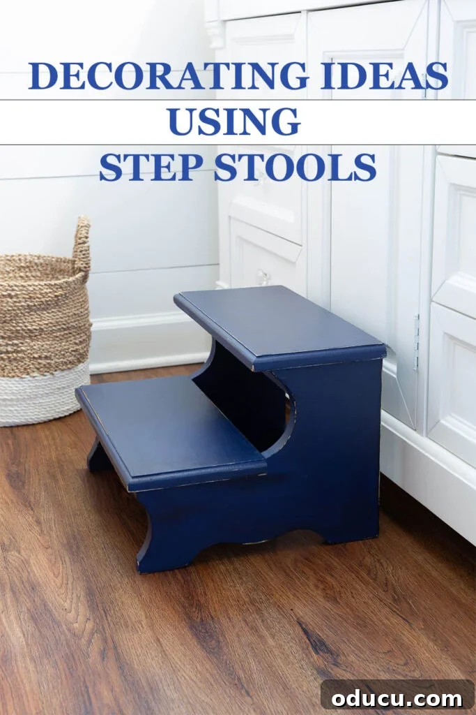 The Unsung Hero Your Home's Must-Have Small Furniture 14 Navy blue painted wood step stool placed in front of a white sink vanity in a bathroom. Text overlay says - Decorating Ideas Usind Step Stools