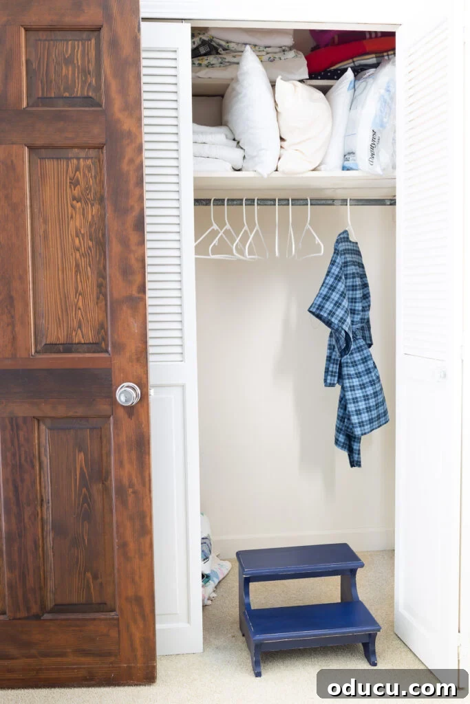 The Unsung Hero Your Home's Must-Have Small Furniture 7 Navy blue wood step stool to stand on to get to high shelf in storage closet.