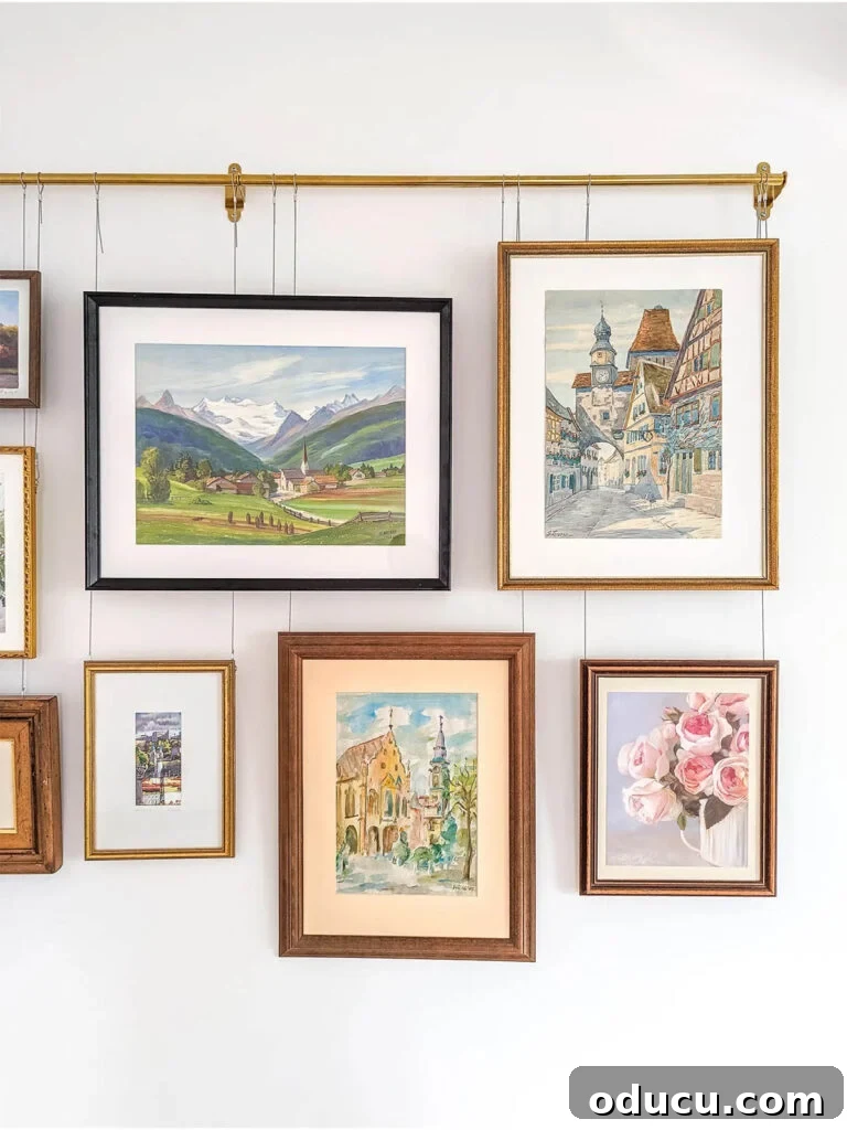Style Discoveries 176 2 A beautifully arranged gallery wall for renters, featuring various framed artworks and photographs, creating a personalized and chic living space without extensive wall damage, as seen on Porch & Penny blog.