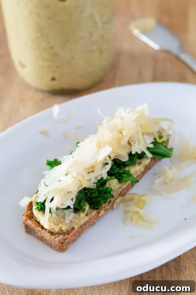 Buckwheat Toast Your Deliciously Wholesome Go To Snack 4 A savory buckwheat toast with Dijon mustard, hummus, steamed kale, and sauerkraut, topped with lemon pepper seasoning.