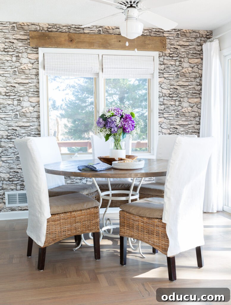 Decorate Wisely Reap the Rewards 6 Kitchen table with 5 dining chairs around it each with a white slipcover.