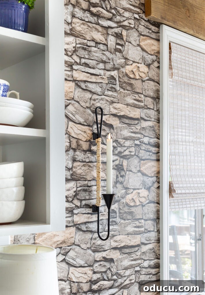 Decorate Wisely Reap the Rewards 9 Black metal and natural cord wrapped candle sconce hanging on wall in kitchen.