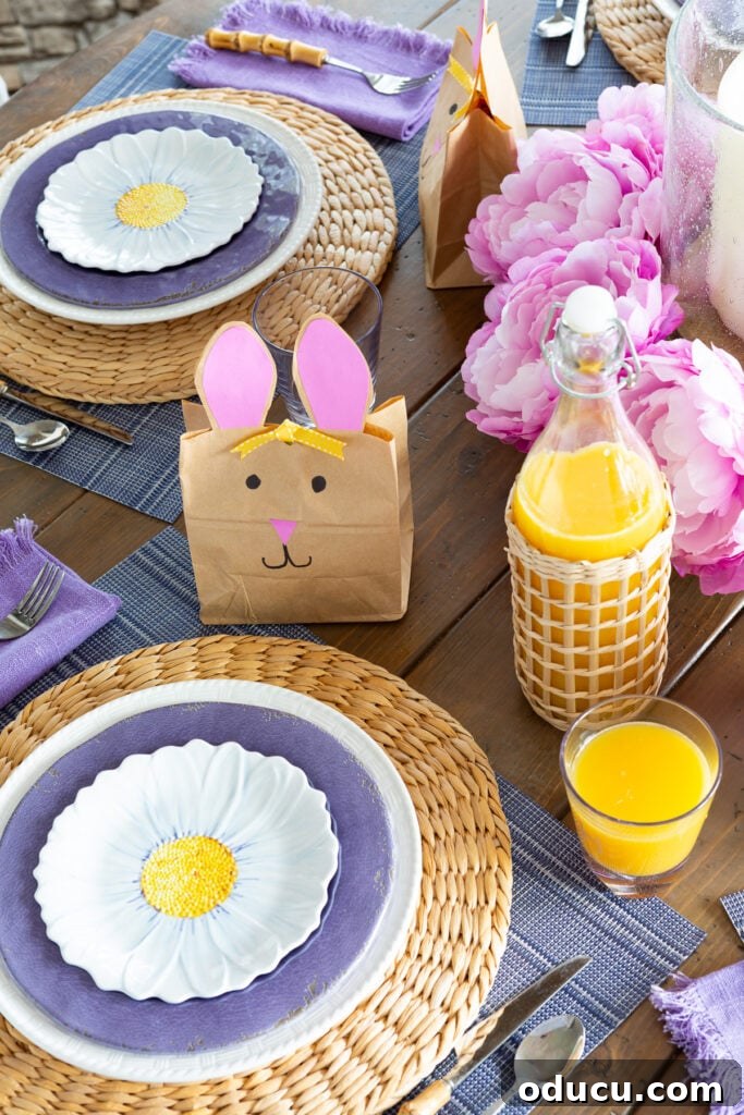 Effortless Easter Table Decor and Centerpiece Ideas 2 Causal Easter table setting with rattan, purple, white and blue accents, featuring a vibrant centerpiece and individual bunny goodie bags.