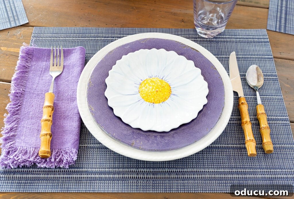 Effortless Easter Table Decor and Centerpiece Ideas 6 Easter dining table place setting without a plate charger, showcasing primary plates and cutlery.