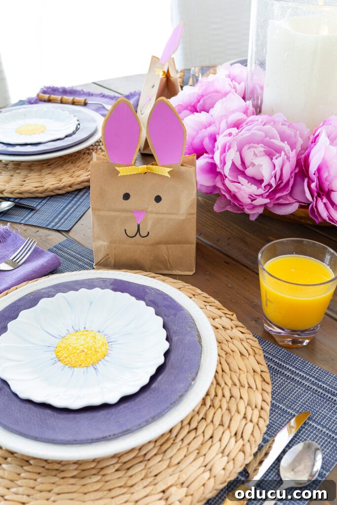 Effortless Easter Table Decor and Centerpiece Ideas 8 Easter table settings, each featuring beautifully layered plates and an individual bunny goodie bag, creating a cohesive and inviting brunch atmosphere.
