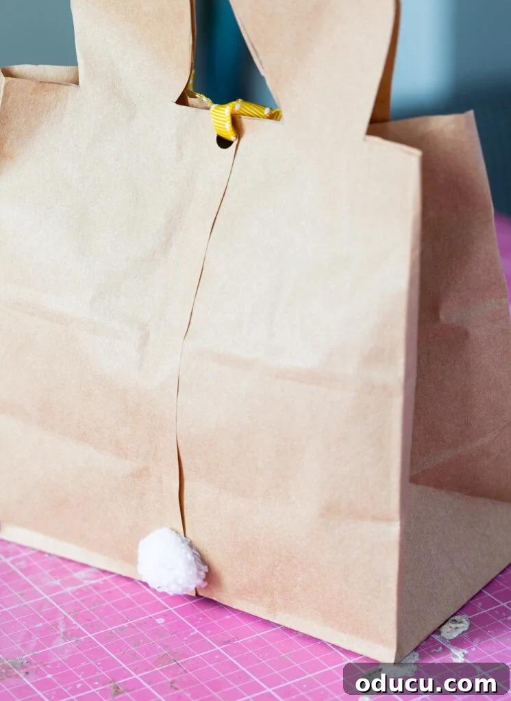 Craft Adorable Easter Bunny Gift Bags 11 Back of a DIY Easter Bunny bag with a white pom pom for a tail.