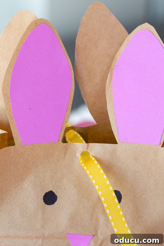 Craft Adorable Easter Bunny Gift Bags 13 how to tie ribbon to close Easter bunny bag with ears.
