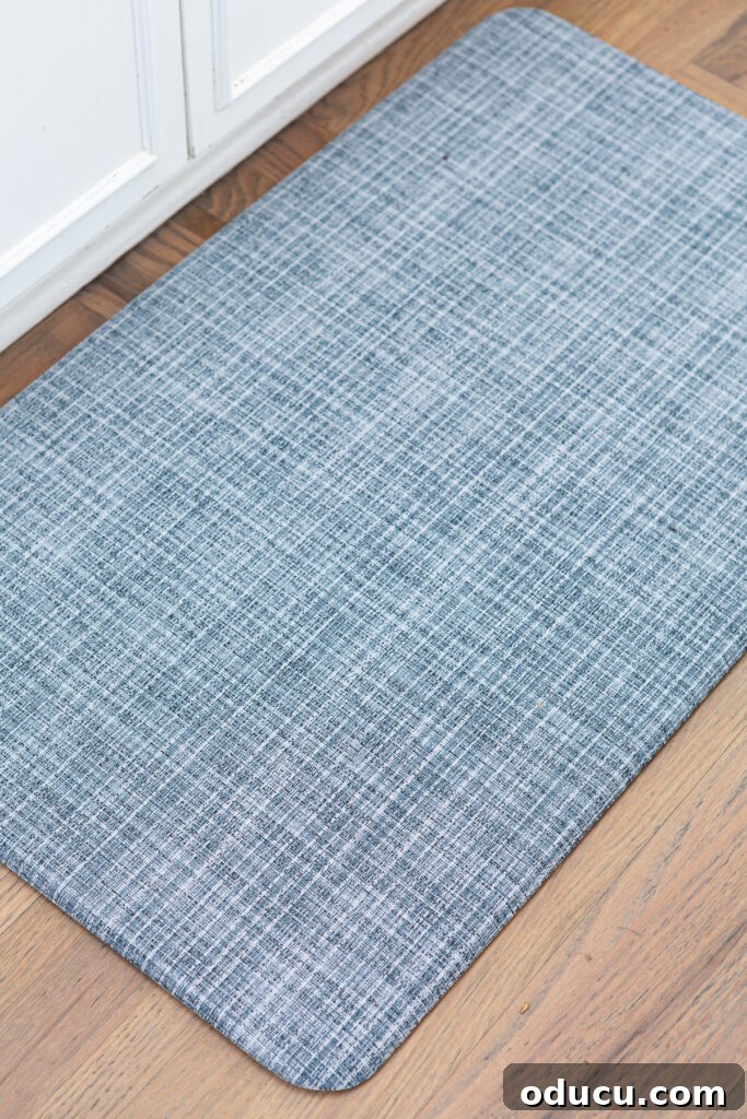 Elevating My Living Room with Area Rugs 12 Close-up of a blue Lucky Brand anti-fatigue wellness mat with a textured weave pattern in a kitchen setting.