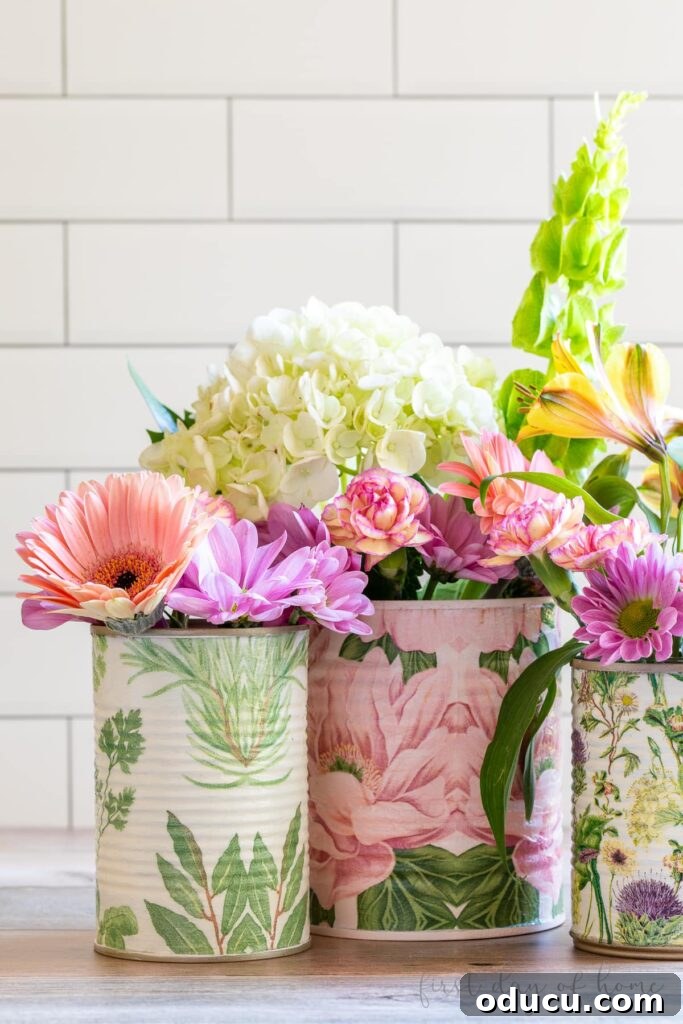 The 189th Style Edition 2 Three beautifully decoupaged cans adorned with floral napkins, perfect for elegant home organization.