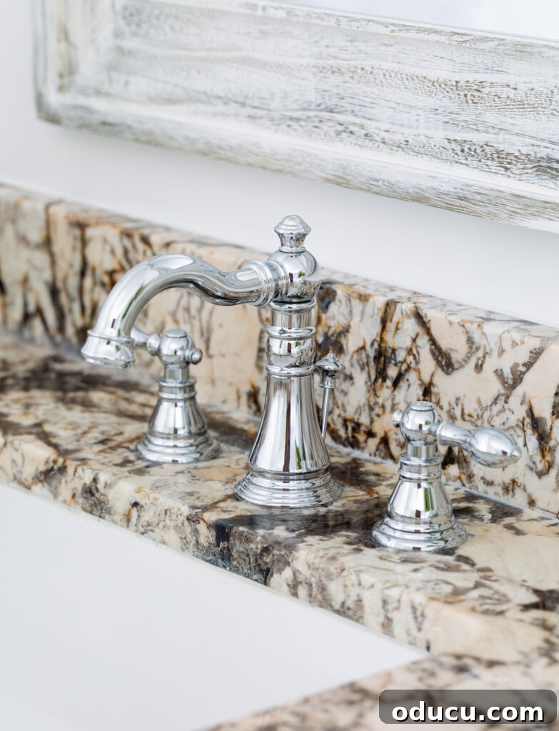 Primary Bathroom Sanctuary Unveiled 14 polished chrome bathroom faucet installed on granite sink vanity.