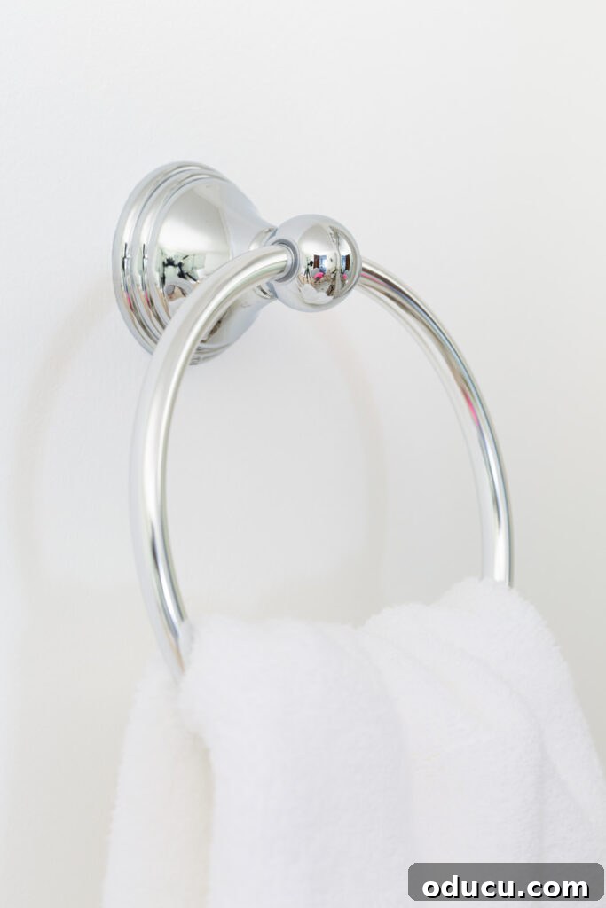 Primary Bathroom Sanctuary Unveiled 22 polished chrome towel ring on white wall.