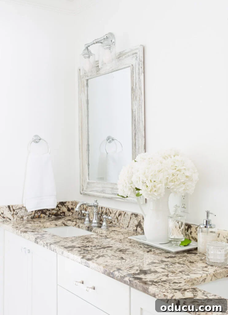 Primary Bathroom Sanctuary Unveiled 24 white flowers in white tray on bathroom sink vanity counter.