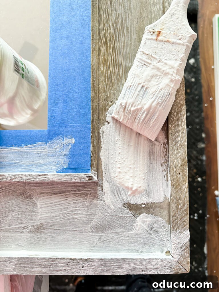 Unconventional Furniture Finishes Beyond Paint or Stain 13 brushing on Vintage Plaster finish on raw wood mirror frame.