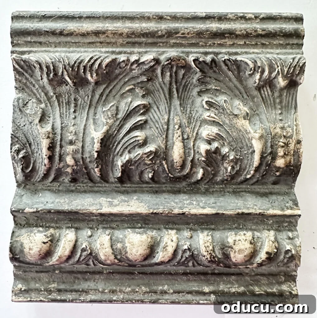 Unconventional Furniture Finishes Beyond Paint or Stain 7 close up of decorative crown molding with an Amy Howard Home speciality finish to make it look old.