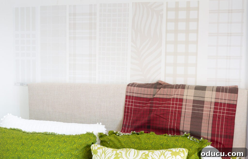 Chic Comfort for Guest Room One 8 Sampling-Love-&-Design-wallpapers-on-wall. Various wallpaper samples from Love vs. Design displayed on a wall, showcasing different patterns and colors.