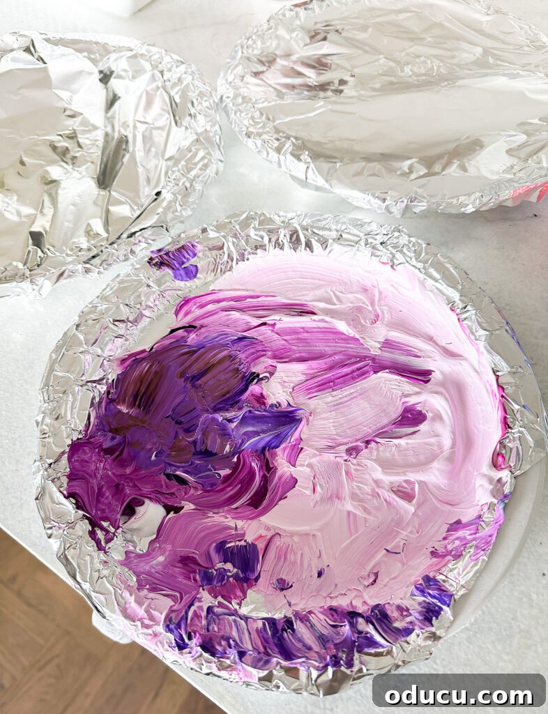 Paint Your Own Canvas: Simple Art for Everyone 11 DIY Acrylic paint palette made using a paper plate lined with foil.