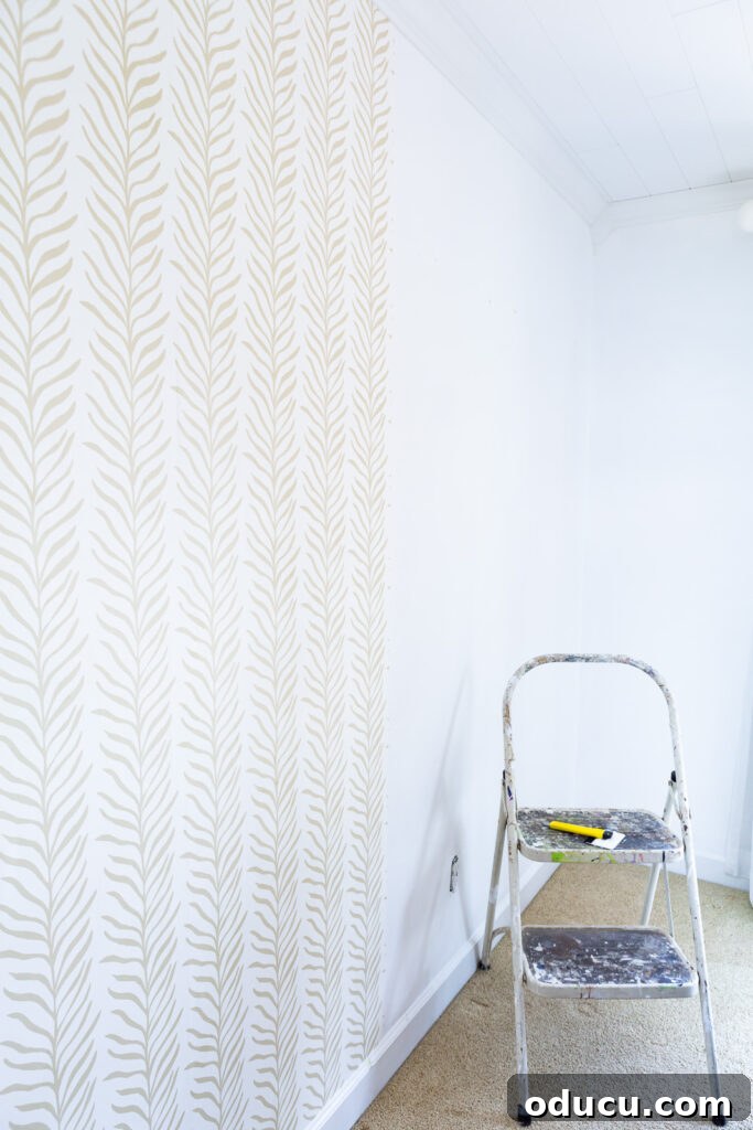 Walls of Welcome 14 The efficient process of installing Love vs Design wallpaper panels on a wall, showing careful alignment and smoothing for a flawless finish.