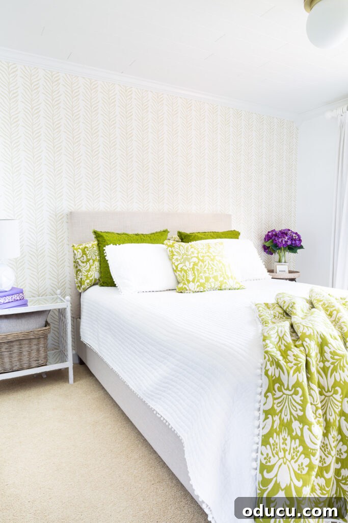 Walls of Welcome 5 A captivating long view of the guest bedroom, beautifully transformed with an accent wall adorned with Love vs Design wallpaper, creating a serene and stylish atmosphere.