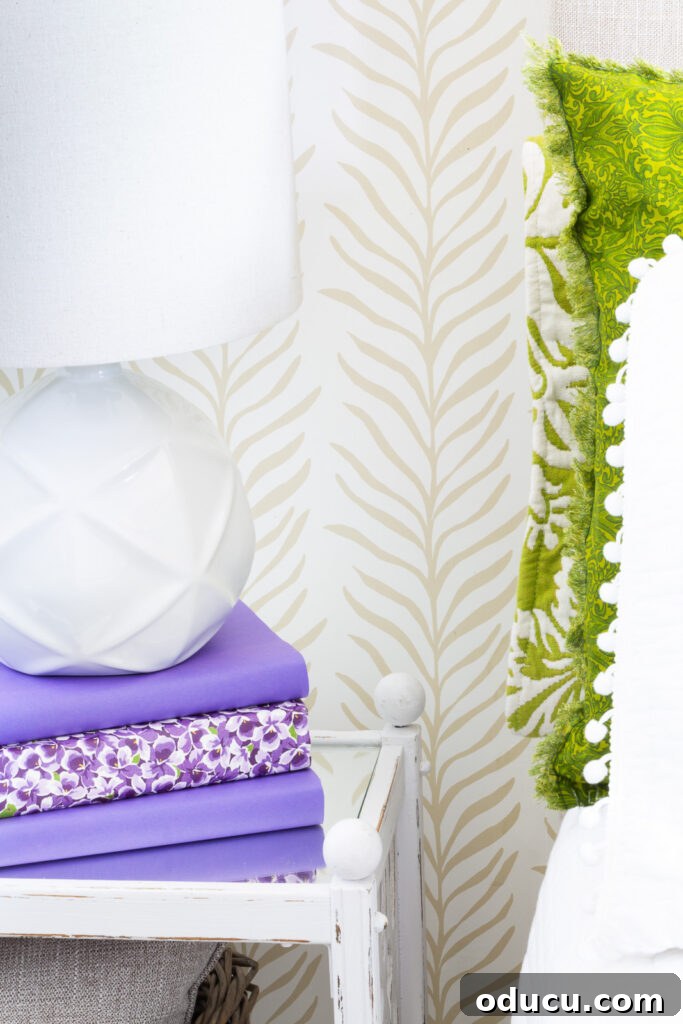 Walls of Welcome 6 A detailed close-up of the Love vs Design Glissade wallpaper in the elegant Vine Thread pattern, showcasing its intricate design and texture on a bedroom accent wall, perfectly complementing the room's aesthetic.