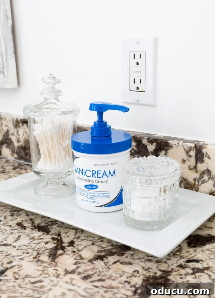 Hold Off on Fall Decorating Try This Alternative 3 Plastic moisturizing cream container on a white tray in a bathroom.