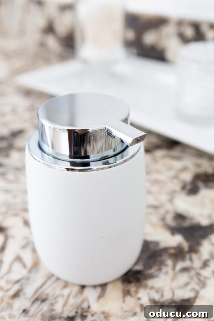 Hold Off on Fall Decorating Try This Alternative 4 White stoneware moisturizing cream decorative pump container that looks pretty on a bathroom counter.