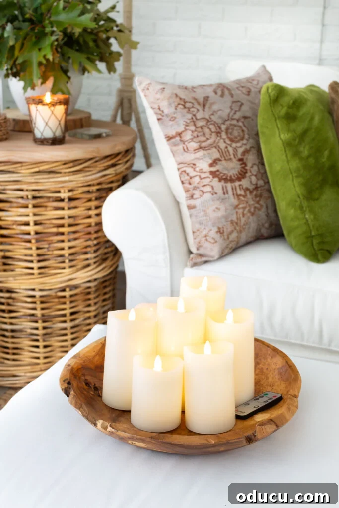 Creative Dyeing for Fabric Decorations 2 Large wood bowl on ottoman filled with battery operated off-white pillar candles in a living room.