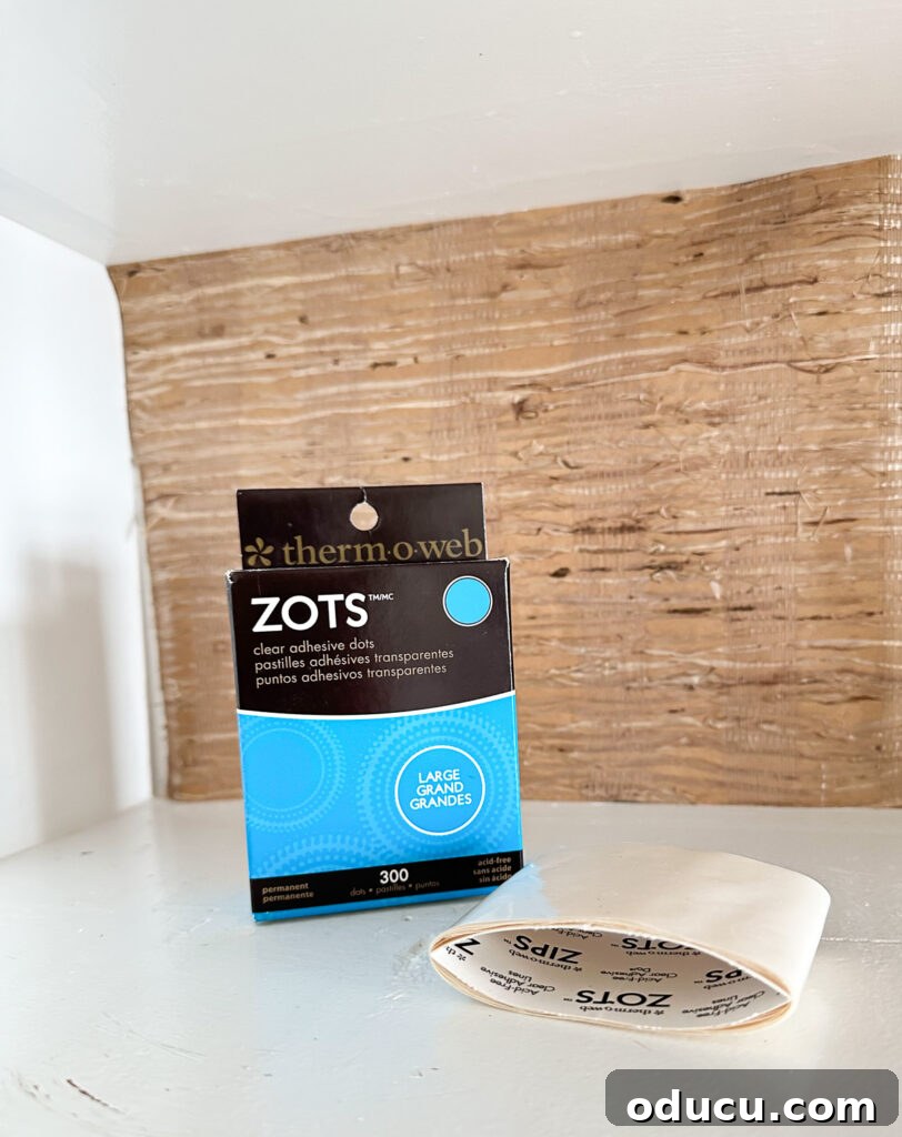 Fall Kitchen Shelves Get a Wallpaper Makeover 12 Zots clear adhesive dots ready to be used to attach wallpaper to the back of open kitchen shelves that are getting a color makeover for fall.