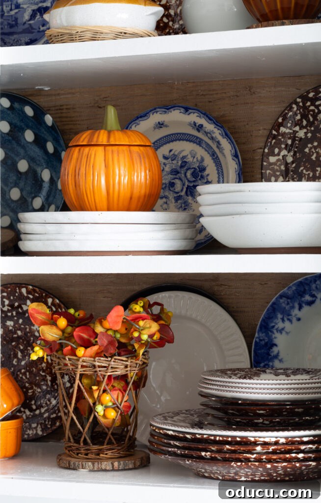 Fall Kitchen Shelves Get a Wallpaper Makeover 4 Fall colored kitchen items displayed on open shelves in a small kitchen decorated for fall.