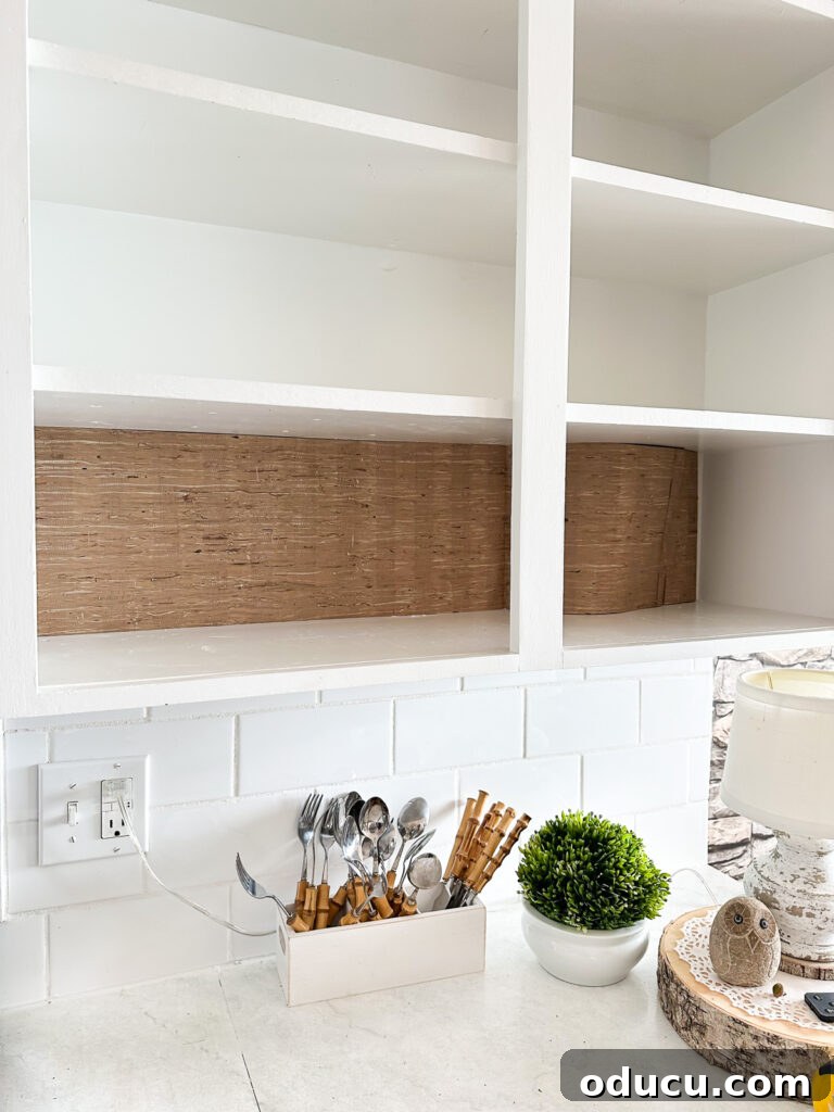 Fall Kitchen Shelves Get a Wallpaper Makeover 9 Add wallpaper to the back wall of open kitchen shelving to decorate it for autumn.