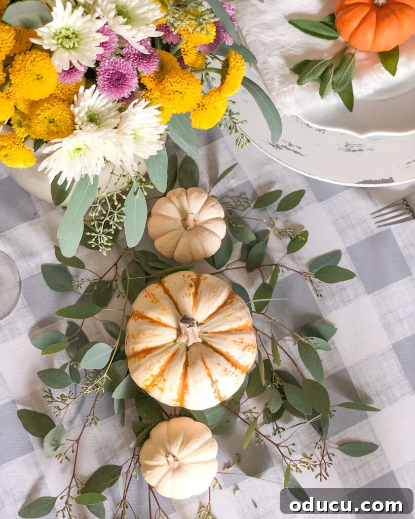 Trend Reports 212 2 Cozy fall table setting adorned with small pumpkins and autumn foliage, creating a warm and inviting atmosphere for seasonal gatherings and home decor.
